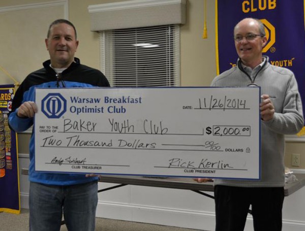 Baker Youth Club Executive Director Tracy Furnival accepts a $2,000 check from Rick Kerlin, Warsaw Breakfast Optimist Club. (Photo provided)