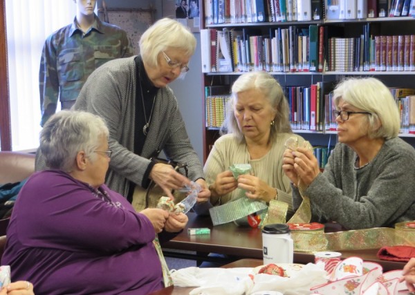 Kay Dabler, standing, instructs Becky Pressler, Mary Erb, and Sharon Altholz in the proper bow tying technique during last week’s bow tying Class.