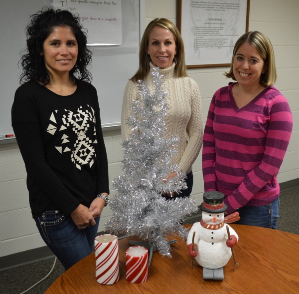 Steffanie Stookey, Shauna Young and Kristen Firestone of Wawasee Middle School PTO prepare for the annual craft bazaar Saturday. (Photo by Tim Ashley)