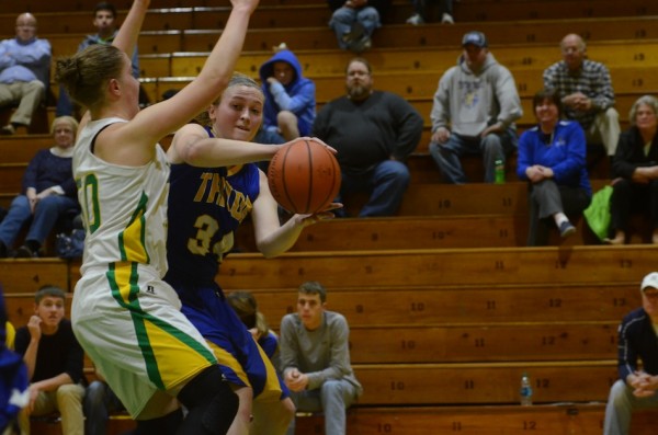 Triton's Lauren Hostrawser tries to drive to the bucket as Anne Secrest of Valley defends Wednesday night.