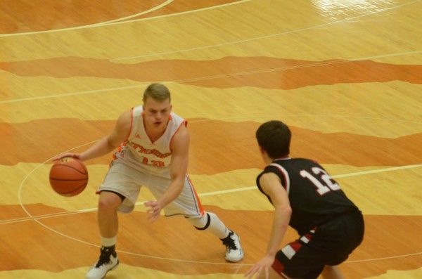 Warsaw's Peyton Long looks to go past David Mcatee of Manchester Thursday night at Warsaw (Photo by Scott Davidson)