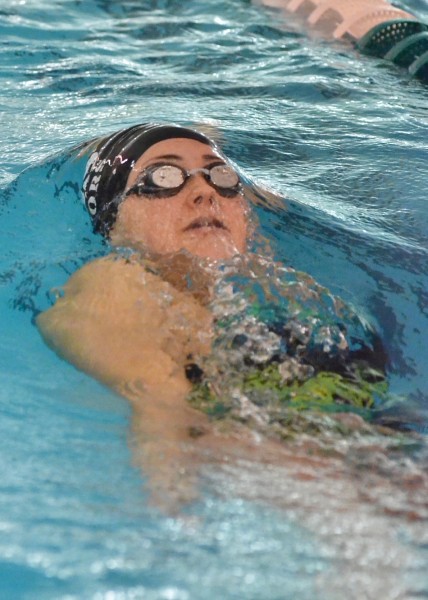 Caitlin Clevenger breaks the water's surface while swimming the backstroke. (Photos by Nick Goralczyk)