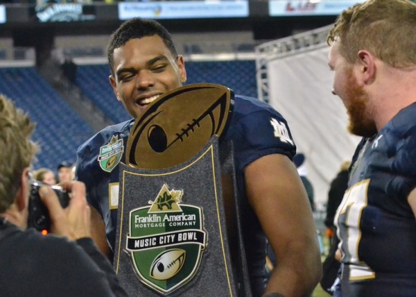 Ronnie Stanley is all smiles as he carries the Music City Bowl trophy off the field for Notre Dame. (Photos by Nick Goralczyk)