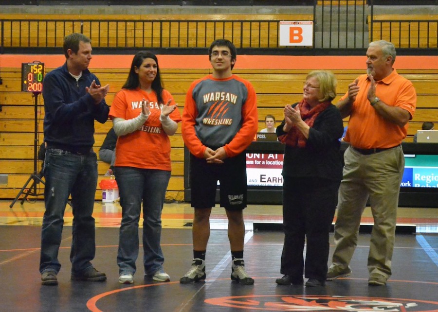 Warsaw's lone senior Rory Nolin (center), stands with his parents and grandparents prior to his match Wednesday night.