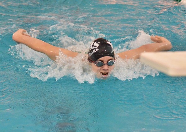 Warrior freshman Spencer Naugler comes in strong during the 100 fly.