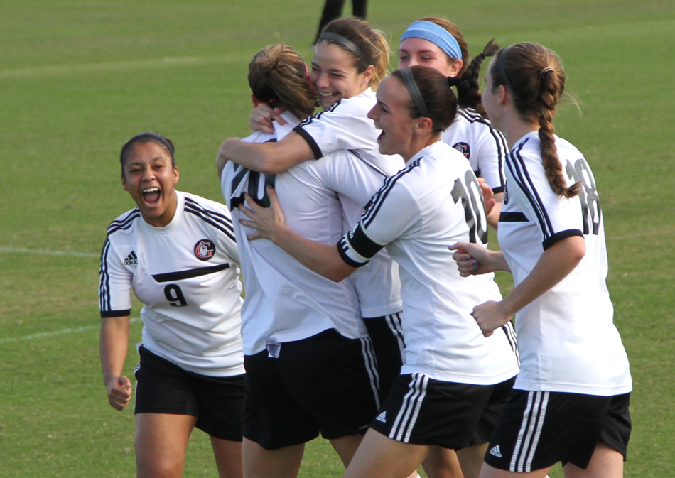 Mallory Rondeau, center, is surrounded by her Grace College women's soccer teammates celebrating a goal. Rondeau was named the NCCAA Player of the Year Wednesday. (Photo provided by the Grace College Sports Information Department)