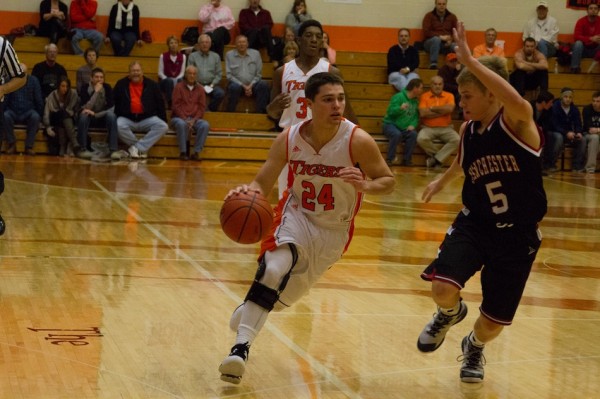 Nick Sands races the ball up court for Warsaw Thursday night. The host Tigers topped Manchester 61-38 (Photo by Ansel Hygema)
