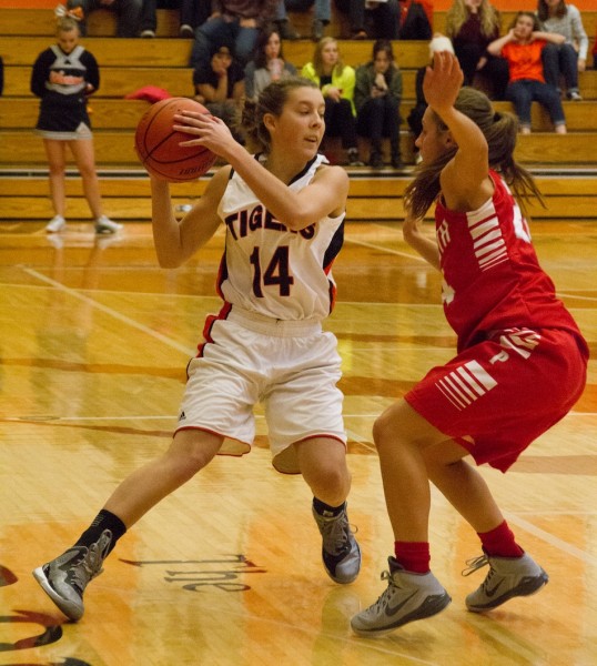 Kenzie Welk protects the basketball from a Plymouth player (Photo by Ansel Hygema)