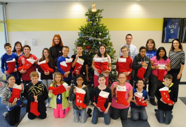 Pictured with the 6th graders, L-R: Mrs. Laura Garza (Paraprofessional), Mrs. Susan Manns (Director, Treasures for Troops), Mr. Kyle Carter (Principal), Mrs. Sandy McClellan (Sixth Grade Teacher), and Ms. Jennifer Kauffman (Vein Institute and Medi Spa)