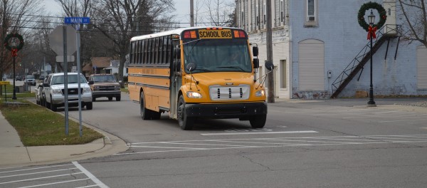 A Wawasee school bus coming from Milford School in the afternoon is stopped at the four-way stop at Main and Emeline streets in downtown Milford. New transportation software is being implemented in the Wawasee district and it is hoped it will increase efficiency, improve service and reduce costs.