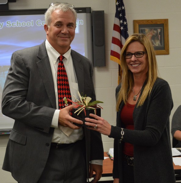 David Cates, left, attorney for the Wawasee Community School Corp., was presented a watch in appreciation for his 24 years of service. Tuesday was the last school board meeting for Cates, who will become a county judge in January. Also show is Rebecca Linnemeier, school board president.
