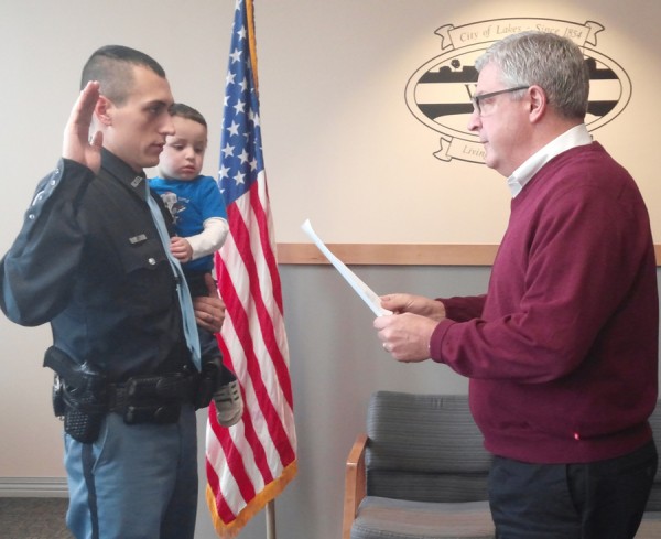 Officer Phil Hawks takes the oath of office with son Gabriel from Mayor Joe Thallemer. (Photo by Deb Patterson)