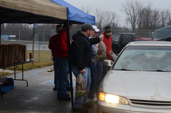 Cars began rolling in to the parking lot at United Steel Workers hall on Little League Drive, Warsaw, where members and their families placed the bag of Christmas dinner makings in vehicles.