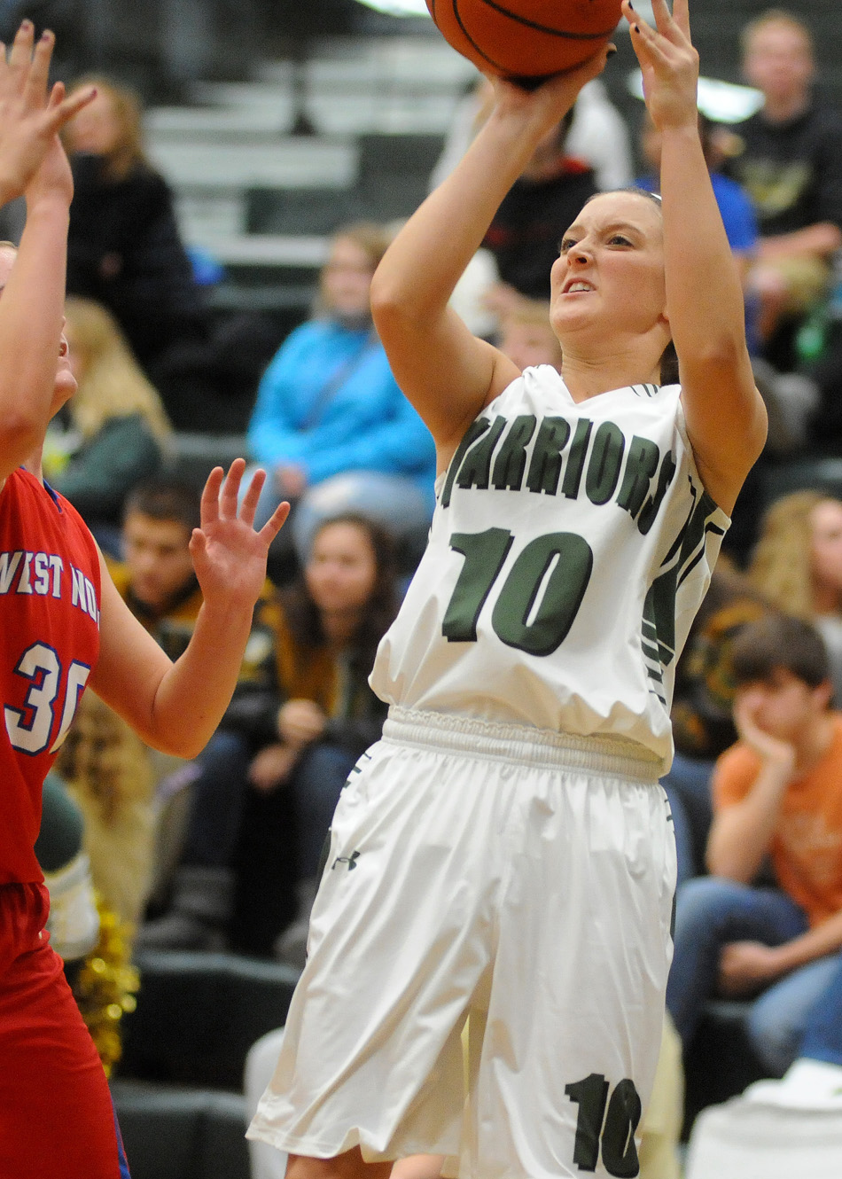 Wawasee's Elizabeth Jackson takes a shot over the defense of West Noble's Becca Schermerhorn.