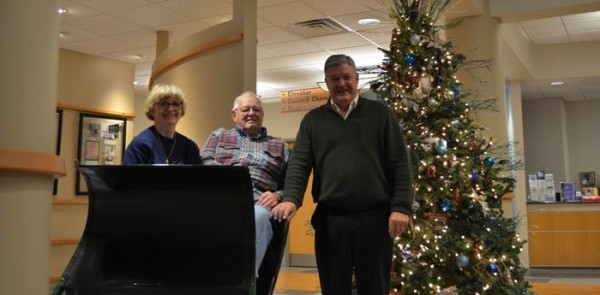 Pictured from left: Mary and Lee Hartle, Mayor Joe Thallmer. The Hartles donated their sled to Warsaw.