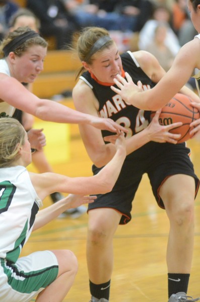 Warsaw's Erin Clemens holds tight to the rock as a host of Concord hands try to get the ball.