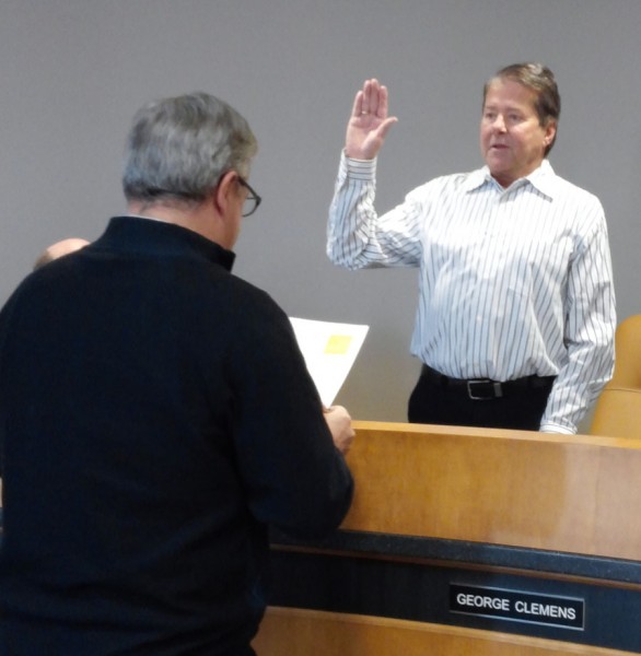 Mayor Joe Thallemer gives the oath of office to George Clemens at today's Redevelopment Commission meeting. (Photo by Deb Patterson)