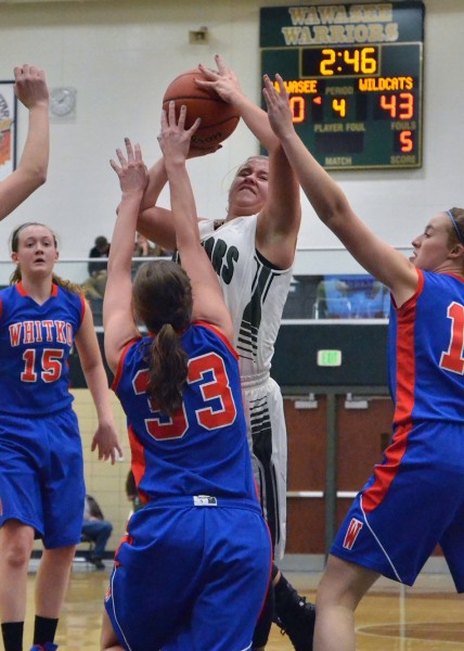 Kylee Rostochak takes a hard foul while going up for this shot.