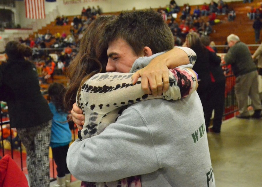 Tristin Ponsler embraces his mother, Des, after winning the 126-pound title.