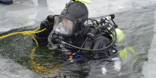 Indiana DNR diver Andrew Harmon finishes his dive and prepares to exit the Waubee Lake waters. (Photo by Keith Knepp)