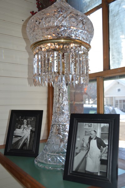 Oscar Hugo, shown in the photos beside it, cut this glass lamp for his future wife, Princess. The piece has since seen many moves before being sent to where it began, Warsaw, by a relative of Oscar and Princess.