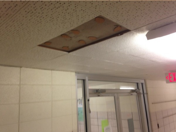 Falling ceiling tiles has caused one teacher to be sent to the ER with a concussion. 