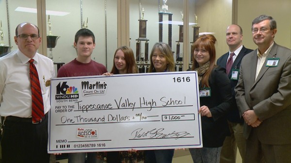 Manager of Martin's Super Market, Warsaw, Shaun Morrow, presents the check to Micah Bradley, Sarah Jones, Susanne Siebrase, Stephanie Anglin, Mike Bendicsen and Brett Boggs.