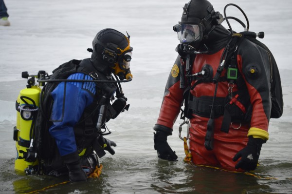 Kosciusko Sheriff's Department Rescue Divers Brandon Hepler (left) and Jim Smith clear the area of dangerous ice prior to the annual Polar Plunge as part of the 2015 Syracuse Winterfest. (Photo by Keith Knepp)