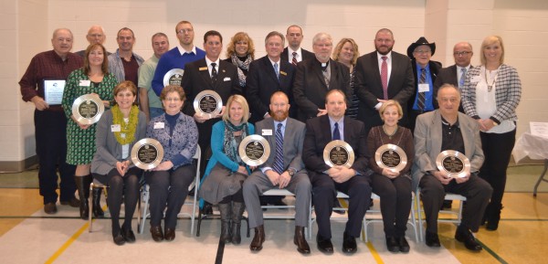 Pictured are chamber award winners and award sponsors. Seated from left are Dawn-Marie Bass and June Rea, Bass Audiology; Kristy and Rustin Rumfelt, Beyond Landscaping; Mike Schmidt, principal of Wawasee High School; Emily Traycoff, Westmain Tavern; and Henry DeJulia, town manager of Syracuse. In the middle row are Peggy Genshaw, Syracuse-Wawasee Historical Museum; Tom Tuttle, Team Tuttle Mortgage; Richard Owen, Owen Family Funeral Homes; Father Larry Biller, All Saints Episcopal Church; Eric Erlenwein, Interra Credit Union; and Tricia Small, Teghtmeyer Ace Hardware. In back are Don McCulloch, Don’s Excavating; Ron Baumgartner, The Papers Inc.; Todd McCulloch and Dan McCulloch, Don’s Excavating; Erick Leffler, Dynamic Spine, representing Rotary Club; Kim Strawbridge, Lake City Bank; Heath Simcoe, Mutual Bank; Amy Rensberger, KeyBank; Dr. Richard Brungardt, Lakeland Animal Clinic; and Steve Fields, Oakwood Resort.