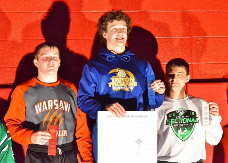 Spencer Gareiss of Warsaw (left), Gage Waddle (center) and Zach Ford (right) stand on the podium as the top three wrestlers in the 160-pound bracket. (Photos by Nick Goralczyk)