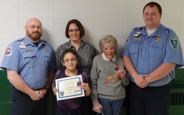 A Life Saver Certificate and Challenge Coin were recently presented to Lori Davila for saving her grandmother's life. Shown, from left, are Darrell Sopher, paramedic; Lori Davila; Lori's Mom Lori; Lori's Grandmother; and Cody Manges, paramedic. Manges and Sopher are the ones that taught Lori how to help when someone is choking. (Photo provided)