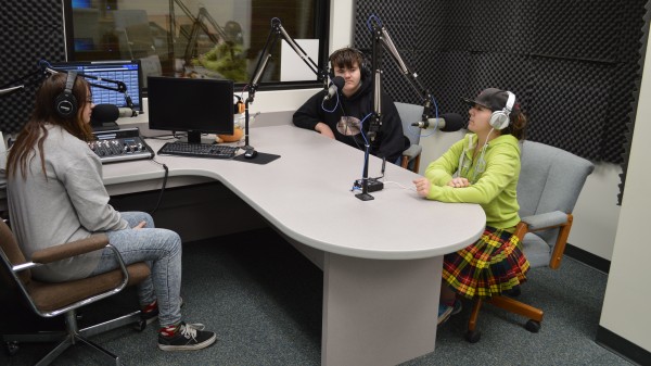 From left, Wawasee High School students Cheyenne Clark, Jeremy David Cates and Erica Grotz are at microphones in the new radio studio at the high school. Warrior Radio WRWT 93.7 FM has been on the air since Dec. 1.
