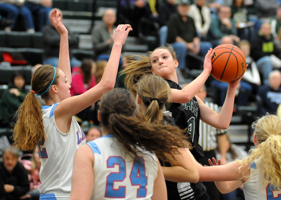 Wawasee's Hannah-Marie Lamle wrestles the ball away from a host of Lakeland defenders during Wawasee's 40-36 overtime win Wednesday night at the Wawasee Girls Basketball Sectional. (Photos by Mike Deak)