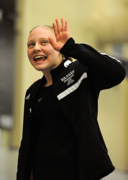 Warsaw's Brenna Morgan waves to the crowd after taking first place in the 50-yard freestyle at the Warsaw Girls Swimming Sectional Saturday afternoon. (Photos by Mike Deak)