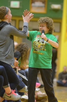 Valley super fan Teri Hughes high-fives Anne Secrest. Hughes has been attending Valley girls basketball games for more than three decades.