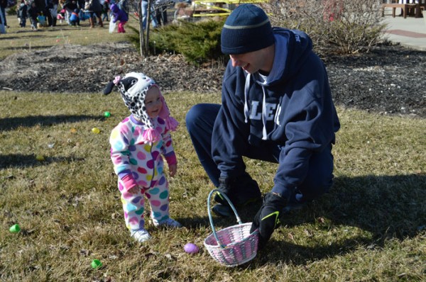 One of the youngest Easter egg hunters in Syracuse on Saturday morning was Hadley Granger, who got some direction from her father, Matt.