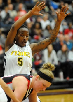 Bethesda's Charmaine Nelson hovers over Grace College's Lindsey Schaefer.