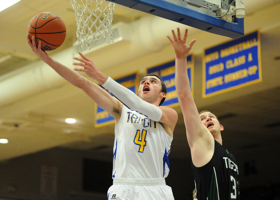 Triton's Joey Corder drives to the bucket for two of his game-high 16 points as the Trojans knocked off LaCrosse, 49-30, in the opening game of the Triton Boys Basketball Sectional Wednesday evening. (Photos by Mike Deak)