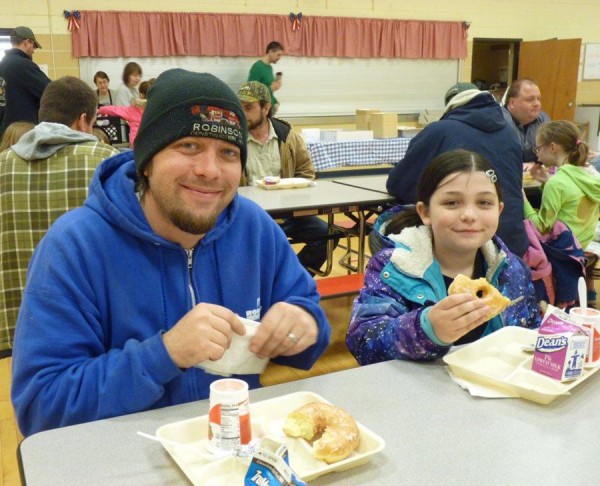 Matthew  Baumgardner and his daughter, Addison, enjoying Donuts with Dads at Pierceton Elementary.