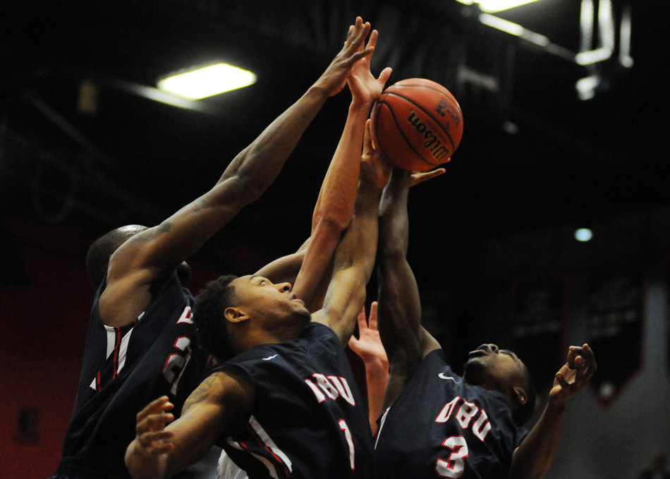 Dallas Baptist players Jordan Walker (1) and Shannon Lilly (3) converge on a rebound during the visitor's 63-55 win over Grace College in the opening game of the NCCAA Men's Basketball Championship. (Photos by Mike Deak)