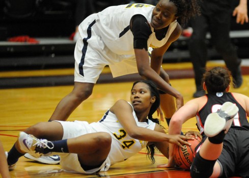 Bethesda's Samone Kelly (34) and Lisette Longomo (12) battle for a loose ball with Grace College's JoEllen Fickel.