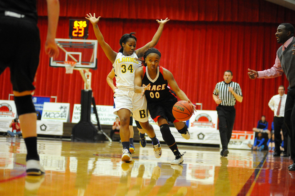 Micah Pollard of Grace college advances the ball upcourt against Samone Kelly and Bethesda Wednesday night in the opening round of the NCCAA Women's Basketball National Championships at Grace College. (Photos by Mike Deak)