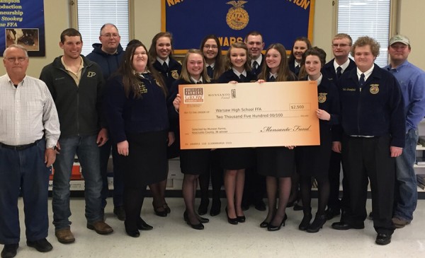 Winning farmer Jeff Thompson and Monsanto Representative Wess Richey present Warsaw High School FFA with a donation of $2,500 from America’s Farmers Grow Communities, a program sponsored by the Monsanto Fund.