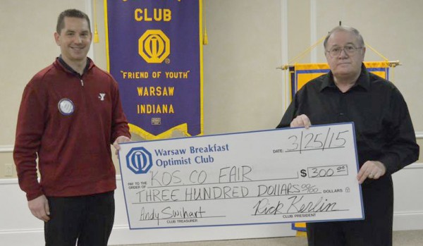 Chad Zaucha. left, representing Warsaw Breakfast Optimist Club presents a check to Jim Reeve, representing the Kosciusko County Fair.