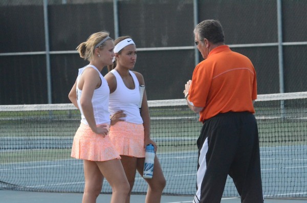Warsaw girls tennis coach Rick Orban has some advice for his No. 2 doubles team of Camille Kerlin and Sydney Hartman Monday night at WCHS,