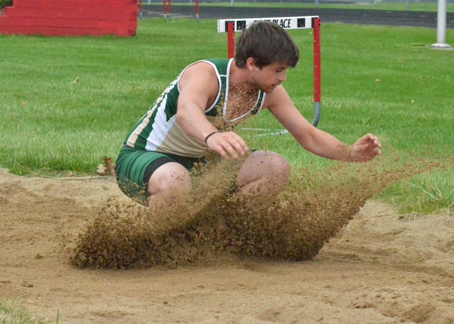 Jacob Hutchinson lands firmly into a third place finish in the long jump for the Warriors in Thursday's loss to Plymouth. (Photos by Nick Goralczyk)