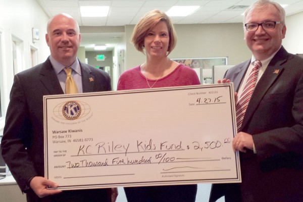 President of Warsaw Kiwanis Club, Renea Salyer, center, presents a check to Alan Alderfer, left, and Michael Bergen, right, of the KC Kids Fund.