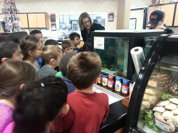 Students learn about "Larry the lobster" while visiting Martins Supermarket.  