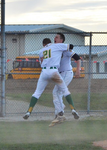 Luke Helton (21) and Austin Perdieu celebrate after Helton scores the game-winning run for Valley in Wednesday's game against Warsaw. (Photos by Nick Goralczyk)
