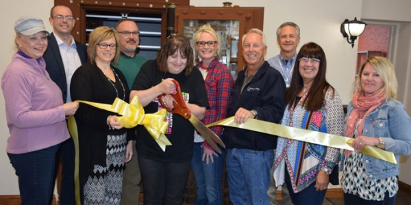 Cutting the ribbon in front, from left, are Sylvia Gargett, Tammy Cotton,  Natalie Abigail,  Dave Mayer, Kathleen Boyts and Kristy Rumfelt. In back are, Heath Simcoe, Chris Cotton, Kristi Martin and Steve Peer. (Photo by Chelsea Los) 